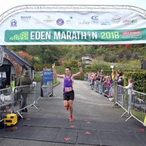 Stu Nicholas crosses the line as winner of the Eden Marathon