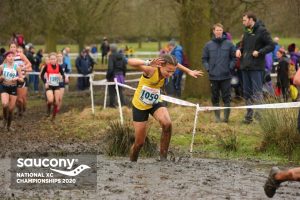 Mariah Marshall goes through the swamp in the National Cross Country Championships