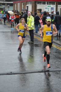 Luke Jackson and Caitlin Peers finishing the Junction Broadstone Quarter Marathon