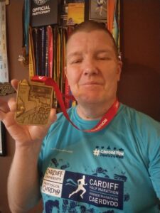 Julian Oxborough with his Cardiff Half Marathon medal