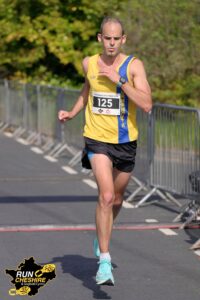 Rich Brawn goes over the finish line in the Wrexham Elite Marathon