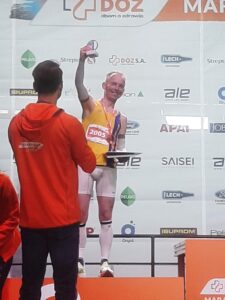 Szymon Chojnacki holds aloft trophy for 2nd placed local runner
