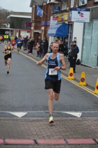 Lewis Clarke winning the Junction Broadstone Quarter Marathon