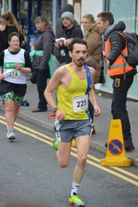 Luke Jackson finishing the Junction Broadstone Quarter Marathon