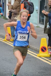 Molly Rasch finishing as first female in the Junction Broadstone Quarter Marathon