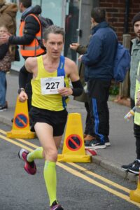 Sam Jackson finishing the Junction Broadstone Quarter Marathon