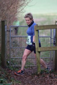 Helen Ambrosen gets through the gate in the Up on the Downs 10k
