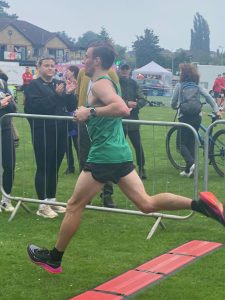Thomas Corbin crossing the line in the South West Inter Counties team half marathon