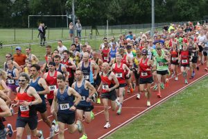The runners on their way round Ashdown Athletics Track
