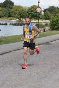 Adam Corbin giving his all in the Poole Festival of Running Relays