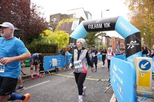 Emma Biggs goes over the line in the Fulham 10k