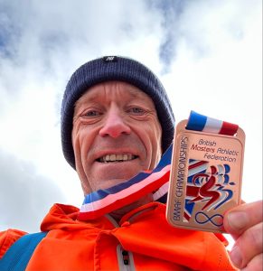 Barry Dolman with his bronze medal from the British Masters 10k Championships