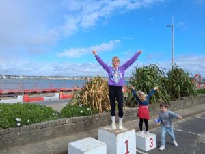Emma Mogridge on the podium after winning Weymouth Half Marathon