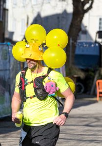 A man with a balloon hat in the Weymouth Half Marathon