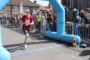 Anna Trehane crosses the line in the Norfolk Marathon