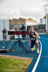 Freddie Rowe after winning the elite men's track mile at the Bannister Miles