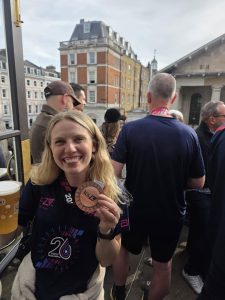 Katie Gunn celebrates with her medal and a pint