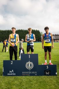 Oliver Canavan on the podium after his track mile race at the Bannister Miles