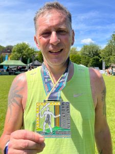 Jason Christian with his medal after the Giants Head Half Marathon