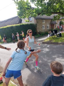 Kate Bowers giving a high five in the Coombe Keynes 10k