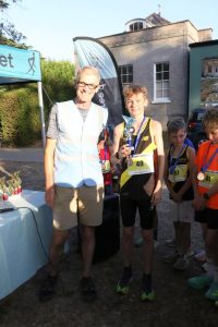 Adam Ewen Matthews collects his trophy for winning the Junior Summer Series