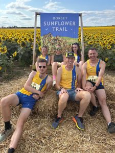 The Bournemouth AC group on the haystack at the Sunflower Stride