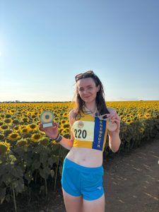 Kitty Cook wit her trophy for second female at the Sunflower Stride