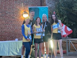 The Bournemouth AC ladies collect their female team winners trophy and prizes